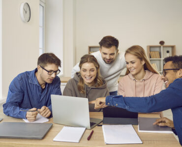 University students using a laptop computer while working on their group project