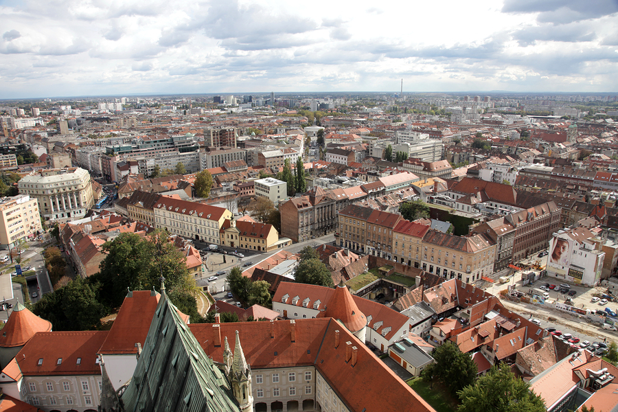 Aerial view of Zagreb, Croatia, showing a dense urban landscape with red-tiled roofs and buildings