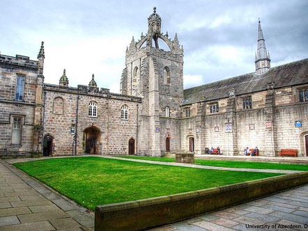 The King's College courtyard at the University of Aberdeen, with a green lawn and stone buildings