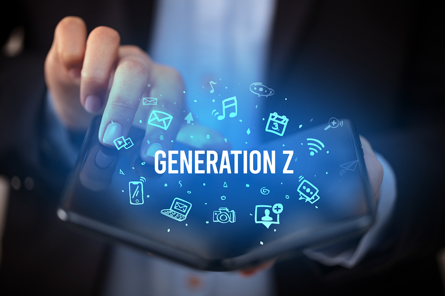 A person holding a foldable smartphone with the text "GENERATION Z" and various app icons floating above it.