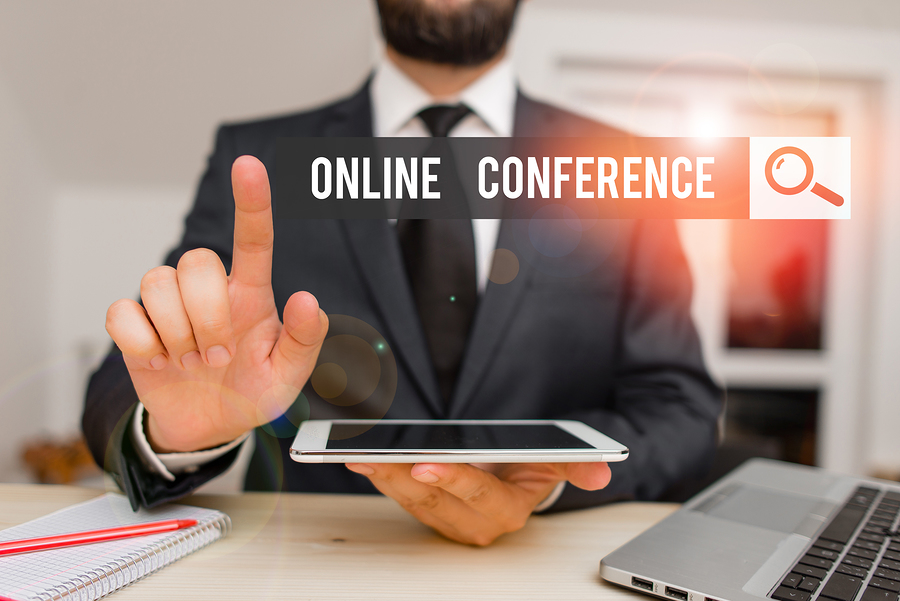 Man in suit pointing at a search bar with the text ONLINE CONFERENCE and a magnifying glass icon.