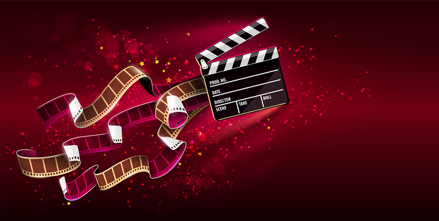 A film clapperboard and a film strip with stars and glitter on a red background