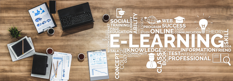 Overhead view of a desk with a laptop, documents, and coffee, with a word cloud about e-learning.