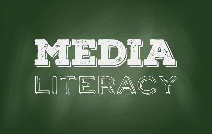 The words MEDIA LITERACY written in white chalk on a green chalkboard.