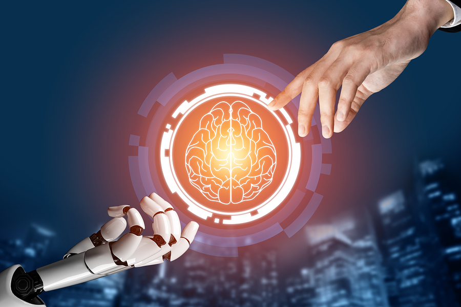 A human hand and a robot hand reaching towards a glowing brain icon, with a city skyline in the background.
