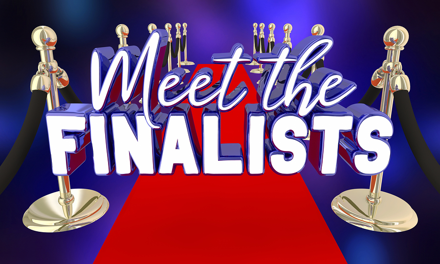 Meet the Finalists in 3D white and blue text on a red carpet with gold stanchions