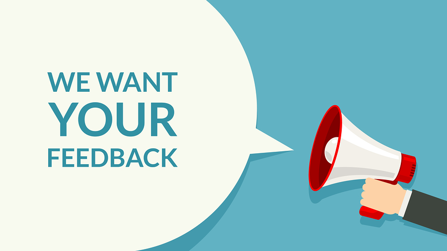 A hand holding a megaphone with a speech bubble saying: We want your feedback