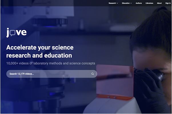 Screenshot of the JoVE website homepage with a scientist looking into a microscope in the background.