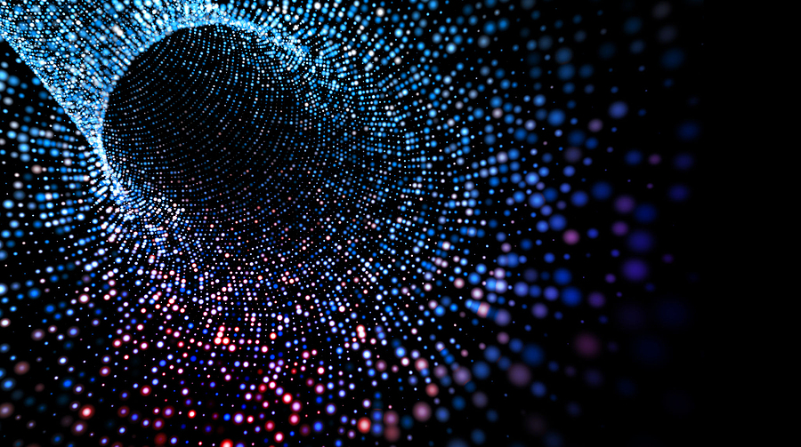 Abstract image of a tunnel of blue, purple, and pink glowing dots on a black background.