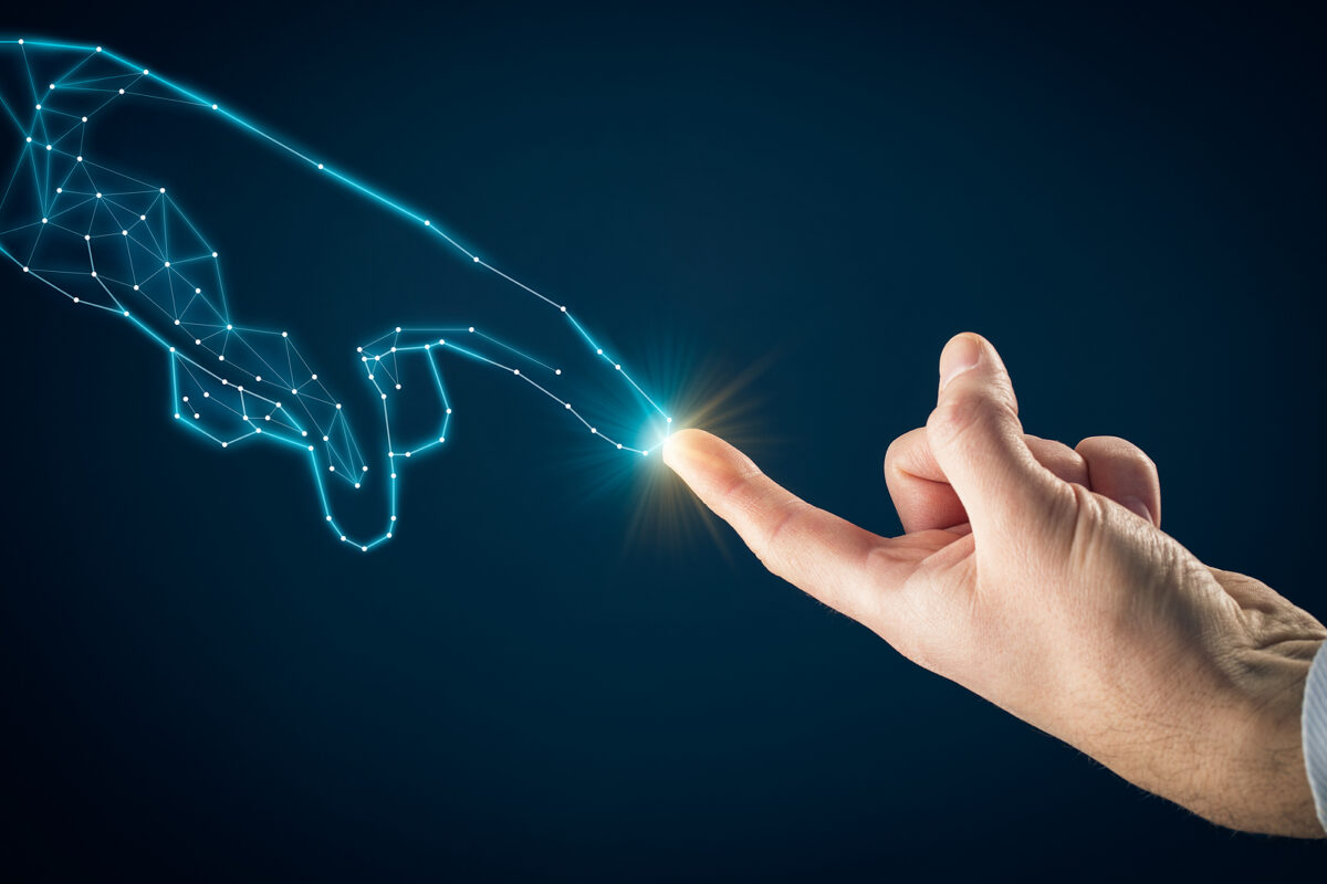 A human finger touching a glowing point on a digital, wireframe hand, symbolising AI interaction.