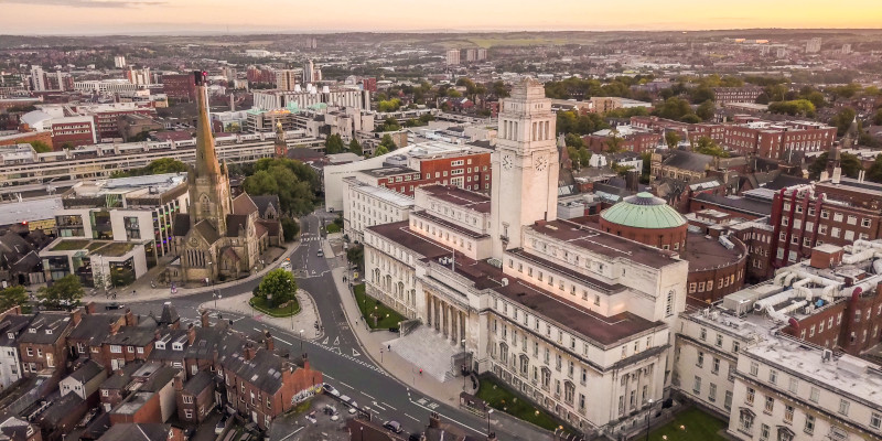 Aerial view of the University of Leeds campus with the Parkinson Building and a church spire.