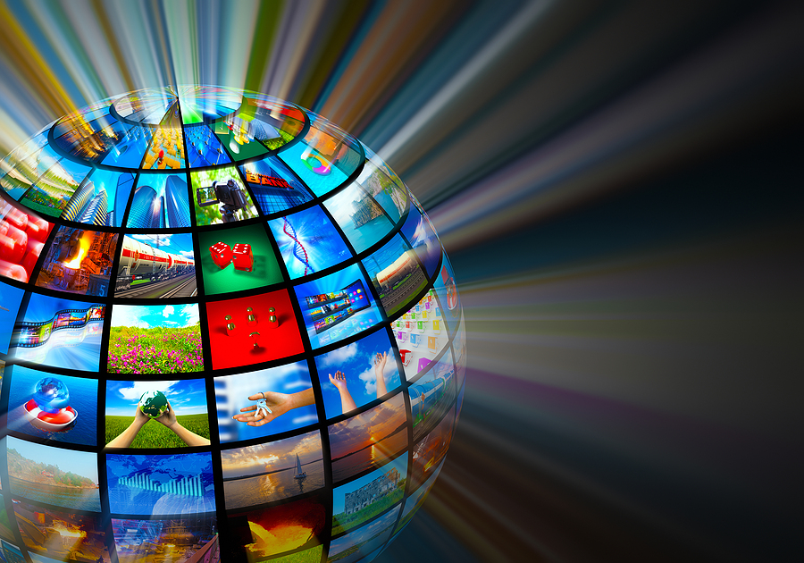 A transparent globe made of many small screens showing various images, with light rays behind it.