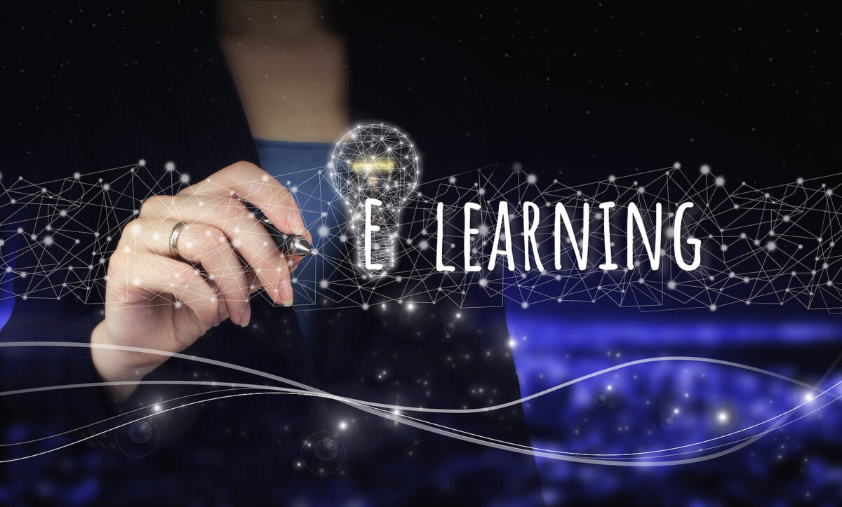 A hand holding a stylus, writing "E-LEARNING" next to a lightbulb made of connected dots.
