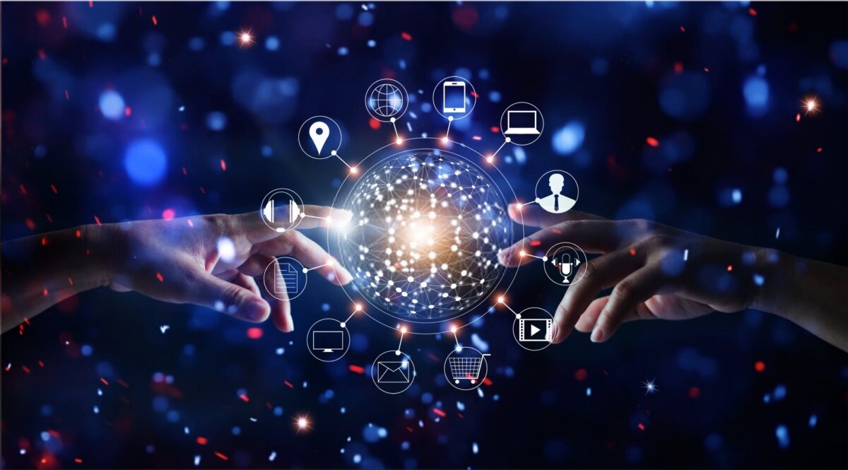 Two hands reaching towards a glowing, networked globe surrounded by digital icons on a dark, bokeh background.