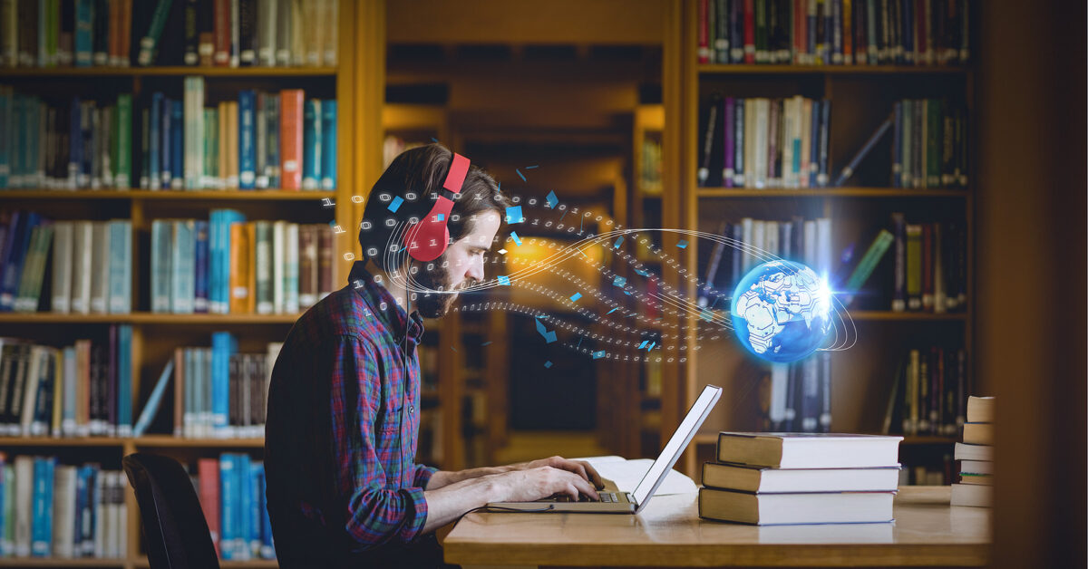 A man wearing red headphones types on a laptop in a library, with digital data flowing to a globe.