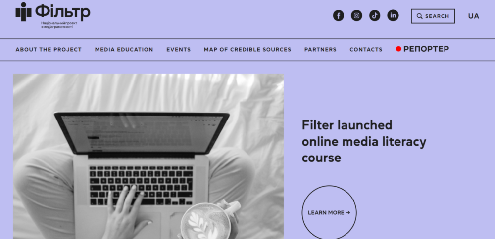 Screenshot of the Ukrainian national project Filter website, showing a person typing on a laptop and the headline "Filter