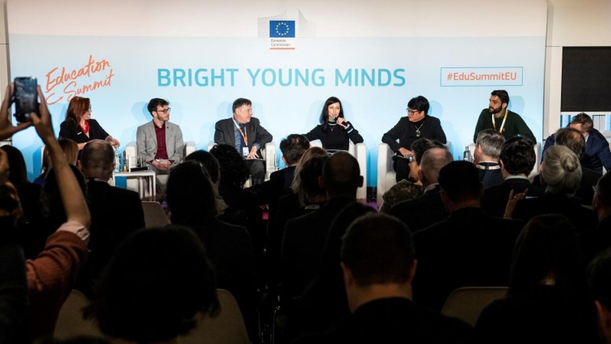 Panel discussion at the European Education Summit with six speakers on stage and an audience