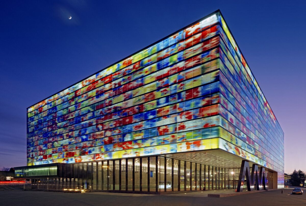 Exterior of the Netherlands Institute for Sound and Vision building at dusk, with a colourful facade.
