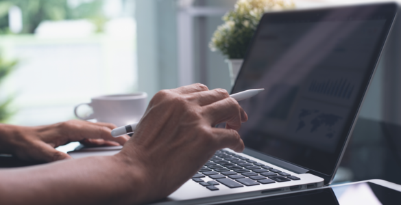 Close up of a person working on a laptop