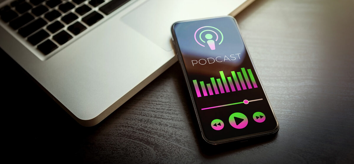 A smartphone displaying a podcast app with a microphone icon, the word PODCAST, and sound bars.