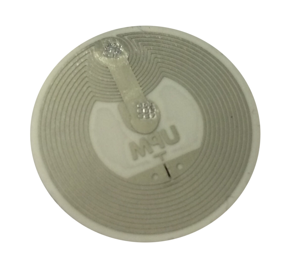 A round, white NFC tag with a visible metallic spiral antenna and a small chip in the centre.
