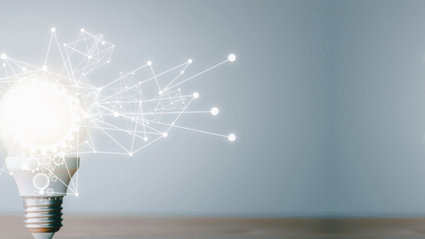 A glowing light bulb with a network of connected dots and lines emanating from it, on a light grey background.
